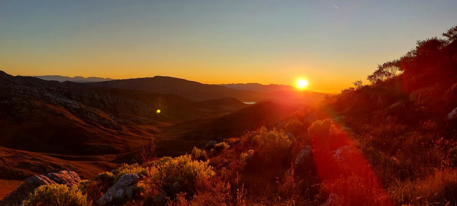 Trail runner in the mountains at golden hour